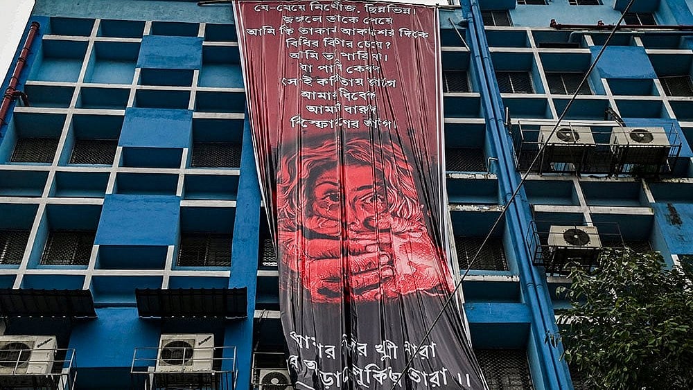 | Photo: PTI : Kolkata rape-murder case: Junior doctors hang a giant poster from the roof of the R G Kar College